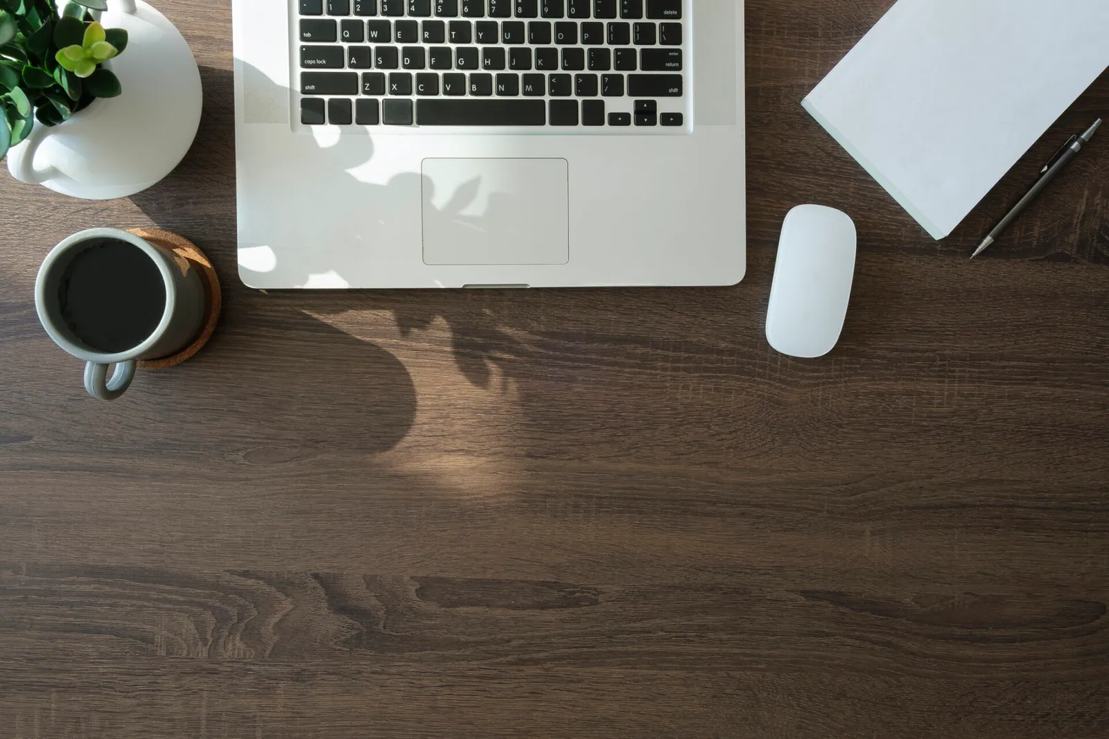 Desk with laptop, coffee and planning notes for a website project